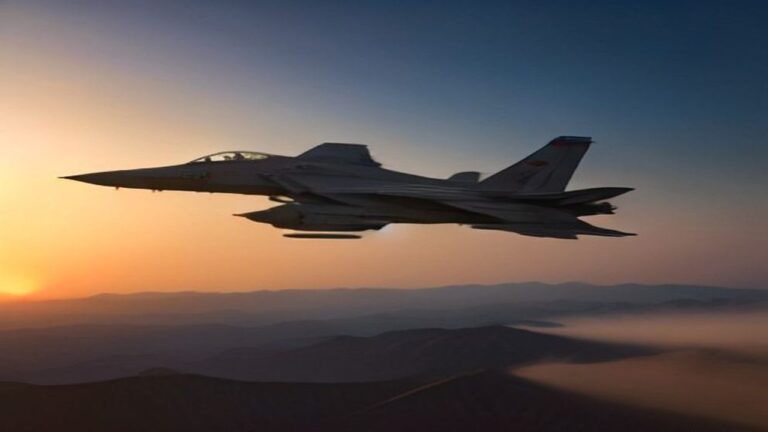 Fighter jet in flight above a desert landscape at sunset