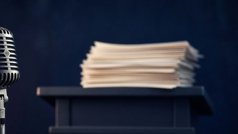 Tall stack of printed transcript pages under cool blue light: Marco Rubio, New York Remarks