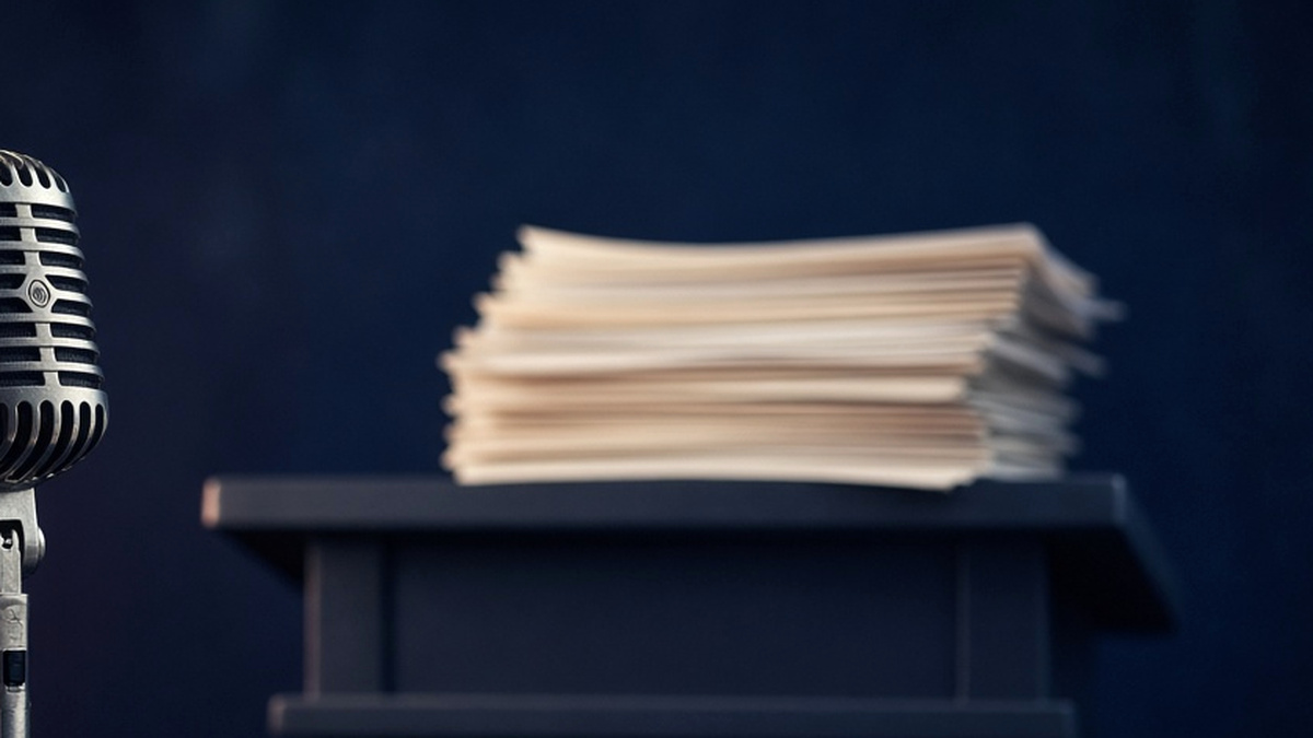Tall stack of printed transcript pages under cool blue light: Marco Rubio, New York Remarks